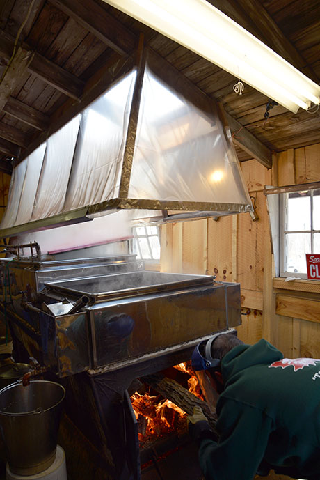 IMAGE: Loading firewood into the evaporator at Soukup Farms.